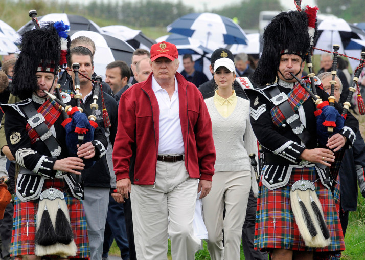 US tycoon Donald Trump (C) is escorted by Scottish pipers as he officially opens his new multi-million pound Trump International Golf Links course in Aberdeenshire, Scotland, on July 10, 2012. Work on the course began in July 2010, four years after the plans were originally submitted.  AFP PHOTO / Andy Buchanan        (Photo credit should read Andy Buchanan/AFP/GettyImages)